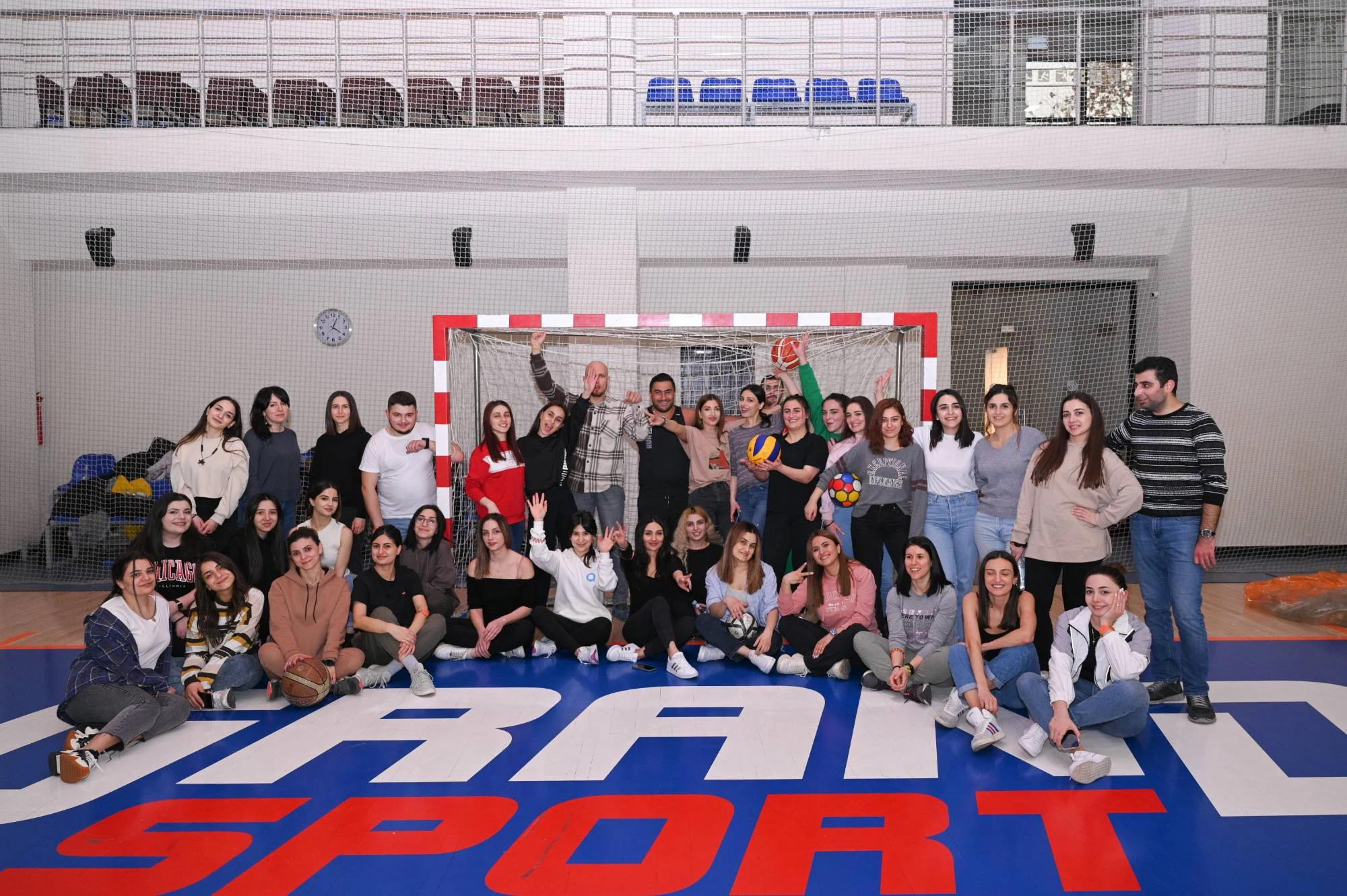 The eWorld group together on an indoor sports court